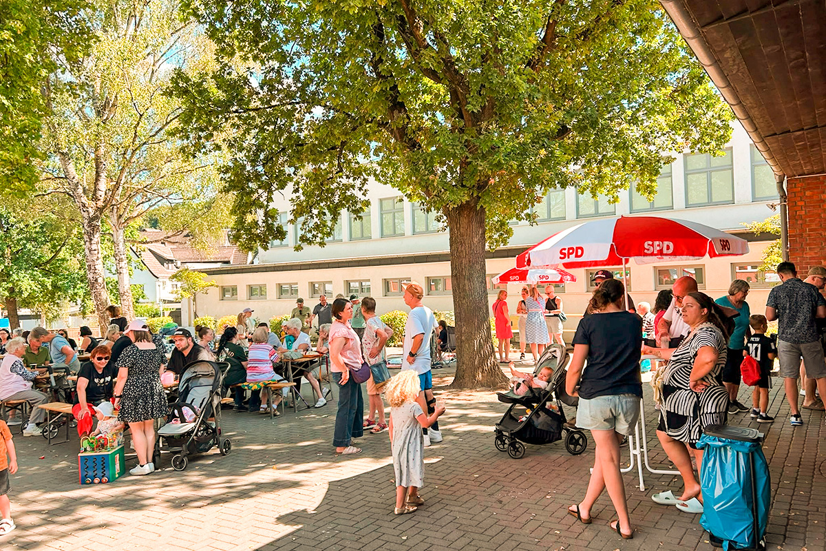 Blick über den Schulhof beim Sommerfest mit Flohmarkt.